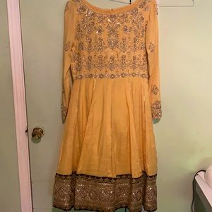 Yellow/Gold anarkali frock with golden stone work. Comes with pants and dupatta